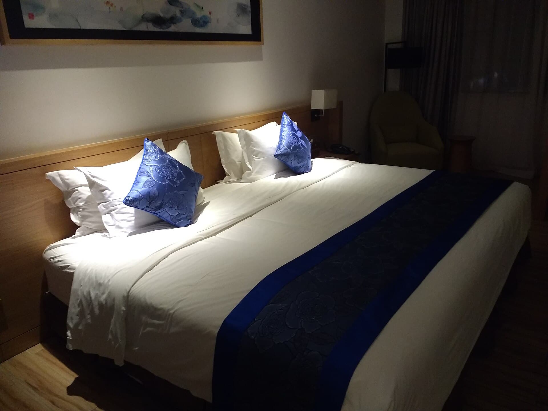 Room photograph — a bed made up as Firm Support 24 would be. Not a photograph of the unit itself.