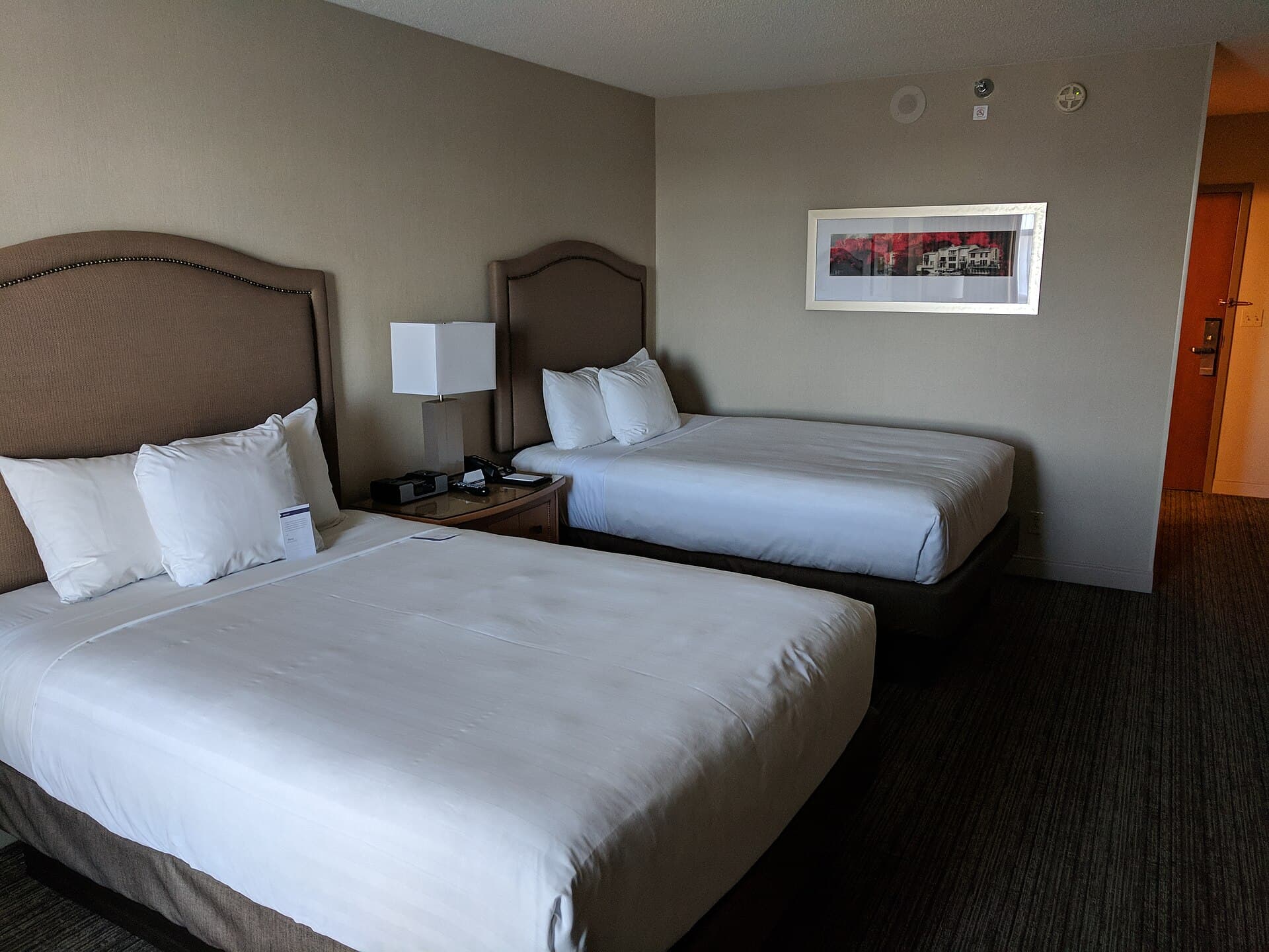 Room photograph — a bed made up as Latex Hybrid 26 would be. Not a photograph of the unit itself.